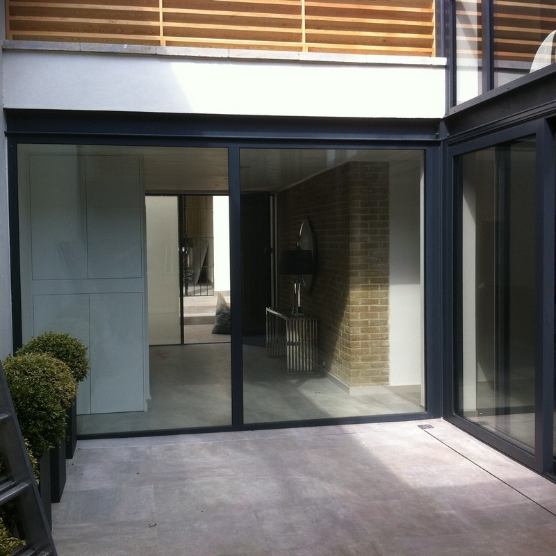 Floor-to-ceiling sliding doors opening to courtyard in Barnet